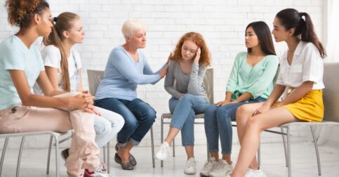 Psychologist Comforting Depressed Girl During Therapy Session